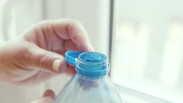 Plastic cap connected to a plastic bottle. Bottle design with the cap attached to the bottle for easier recycling of waste.