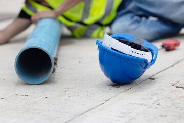 Worker lies on construction site floor with safety helmet suffer from construction accident