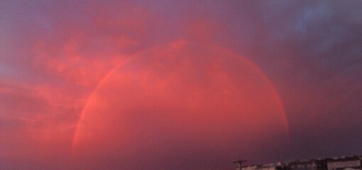 Pink rainbow in the sky with sunset