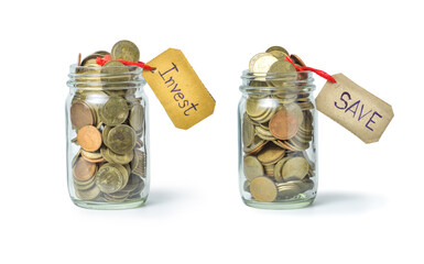 glass jars filled with coins labeled Invest and Save, symbolizing financial planning focus on money management strategies.