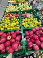 Colorful apples on display in “Alleya” supermarket, Russia. June 2025, top view. Editorial photo taken in a grocery store.