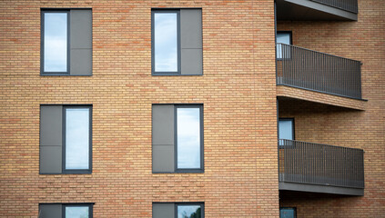 Fototapeta premium Contemporary apartment brick wall design with modern window feature in city residential real estate property exterior