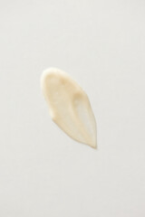 Cosmetic retinol cream texture on white background. Beige minimal skincare beauty product smear, above vertical