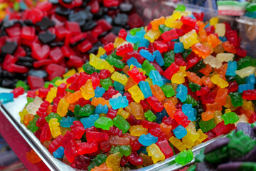 A vibrant pile of colorful gummy bears and candy, highlighting bright artificial dyes which are now...