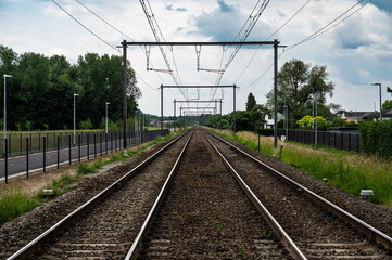 Perspective view over double  empty railway tracks in Leuven, Flemish Brabant Region, Belgium