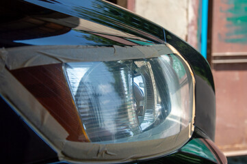 Polishing enhances the clarity and condition of the car headlight, showcasing detailed...