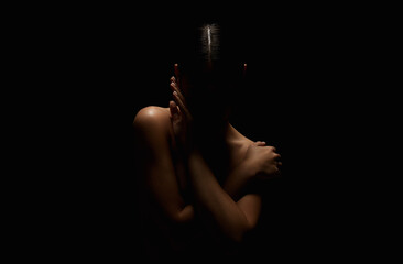 Nude Woman silhouette in the dark