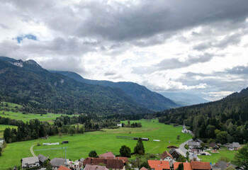 aerial view of village in the julian alps (slovenia) with mountains in the background beautiful...