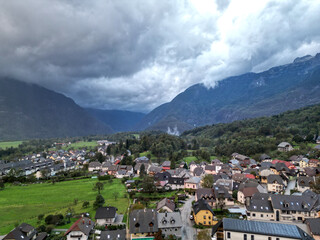 Obraz premium scenic view of bovec slovenia, small european village in the julian alps with beautiful mountains (aerial drone birds eye view looking down) mountain landscape hills outdoor adventure soca valley
