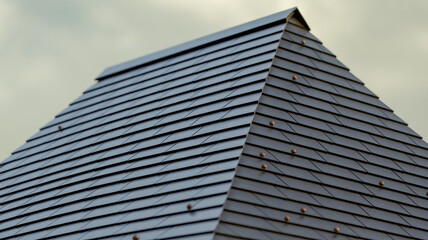 A close-up architectural detail of overlapping black diagonal roof shingles