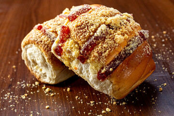 Sweet bread:
Sweet buns with vanilla cream on the brown wooden table and black background