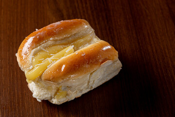 Sweet bread:
Sweet buns with vanilla cream on the brown wooden table and black background