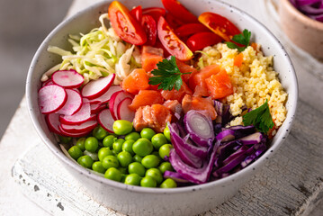 Balanced healthy bowl with vegetables and salmon