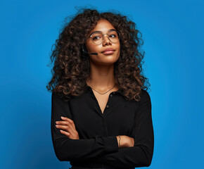 Confident woman wears headset in front of blue backdrop during a business call
