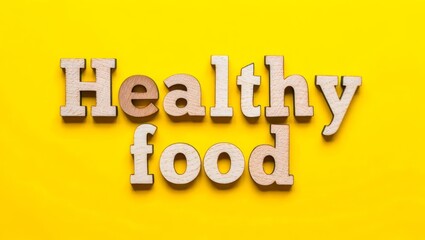 Healthy Food Concept Wooden letters spelling out Healthy Food against a vibrant yellow background.