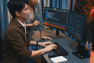 IT developers discussing with point to intelligent website development coder system running data...