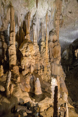 view of rock formation inside cave in postonja slovenia (stalagmite and stalactite formations inside below ground)