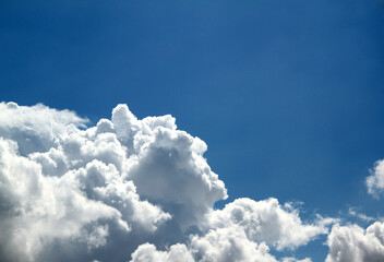 Blue sky with large snow - white clouds