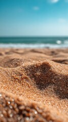 Close up of beach sand with ocean in background creating relaxing summer scene
