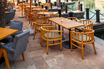 Cafe furniture near city water channel.