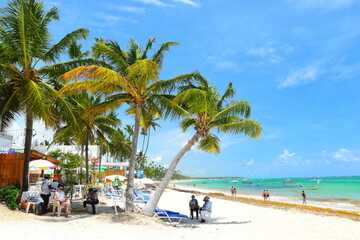 El Cortecito, Punta Cana, Dominican Republic- June 12, 2025: People walking along the coastline and sunbathing on one of the best beach in Caribbean area. Lots  of seaweed, specifically Sargassum.