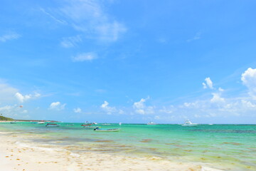 El Cortecito, Punta Cana, Dominican Republic- June 12, 2025: People walking along the coastline and sunbathing on one of the best beach in Caribbean area. Lots  of seaweed, specifically Sargassum.