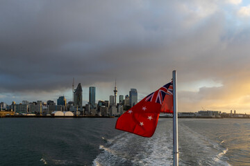 New Zealand Flag on Ferry with Auckland City Skyline at Sunset