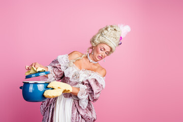 Elegant young woman in a historical costume holding a pot, with a humorous expression against a vibrant pink background.