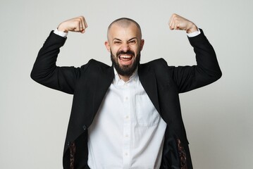 A strong businessman shows his muscles and expresses winning attitude and achievement.