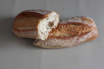A broken freshly baked rustic baguette.