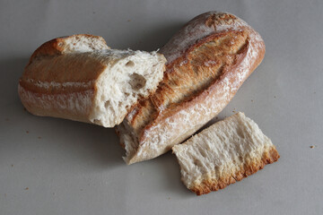 A broken freshly baked rustic baguette.