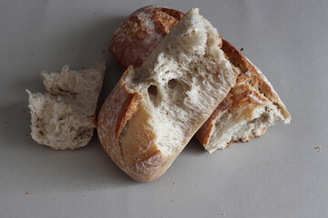A broken freshly baked rustic baguette.