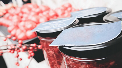 Glass jars filled with homemade jams, pickles, and preserved vegetables.
