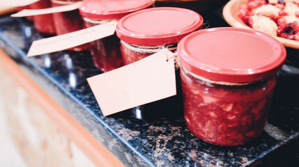 Glass jars filled with homemade jams, pickles, and preserved vegetables.