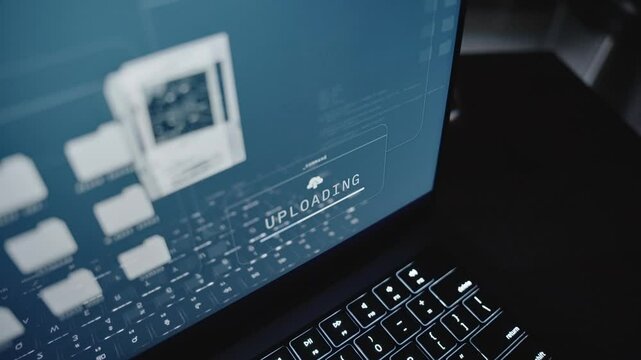Close up on laptop computer screen uploading top secret documents to server. Online remote connection stealing government classified confidential information files copying to cloud by spy or insider