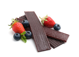 Tasty fruit leather, strawberries and blueberries isolated on white