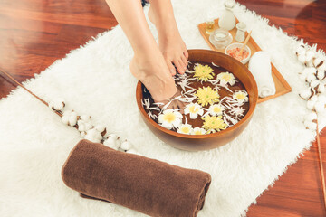 Woman indulges in blissful foot massage at luxurious spa salon while masseur give reflexology...