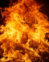 Fiery orange and yellow flames burn intensely in the darkness