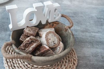 Assortment of halva. Uzbek cuisine. Halva is a sweet confectionery product made from ground sesame seeds or sunflower seeds combined with sugar and nuts. Oriental sweets