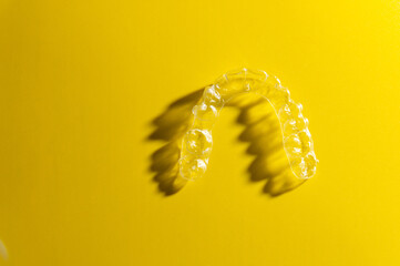 Invisible orthodontic cosmetic aligners on a gradient color background, teeth aligners, plastic...