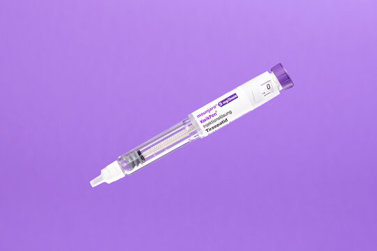 image of a Mounjaro KwikPen containing tirzepatide, used for diabetes and weight management treatment. The injector pen is isolated on a purple background. Visible branding and dosage label.