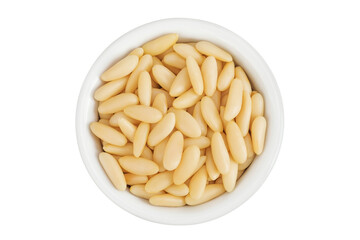 Shelled European pine nuts in ceramic bowl isolated on white background with full depth of field. Top view. Flat lay