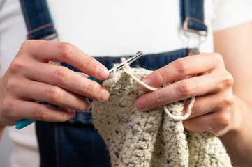 Hands of woman doing crochet, housework. Handmade clothes, evening hobbies