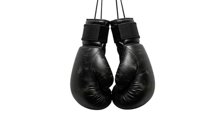 A pair of black boxing gloves hanging against a dark background in a studio setting close up shot