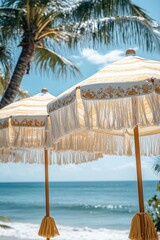 Beachfront scene with decorative umbrellas under palm trees on a sunny day by the ocean