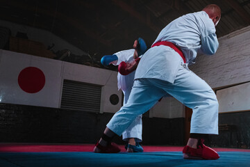 Teenage Boy Practicing Karate with His Father and Instructor