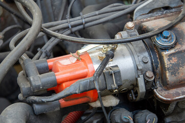 Close-up view reveals the ignition coil, wires, and components of a car engine, highlighting the...