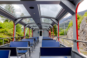 Scenic train interior showcasing panoramic windows in the mountains