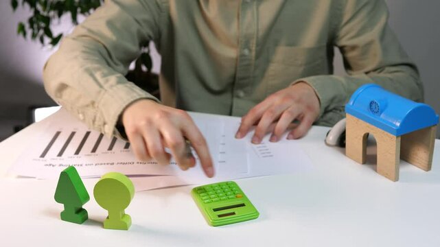 A man with statistical data and indicators, reads them, recalculates. The boss studies reports and forecasts, checks the entered data. Social projects.