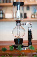 Vacuum coffee maker brewing fresh coffee in cafe